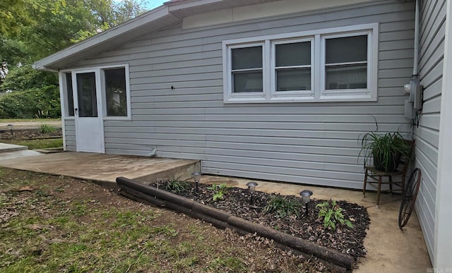 view of side of property with a patio