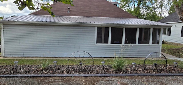 view of home's exterior with a sunroom