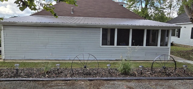 view of home's exterior featuring a sunroom