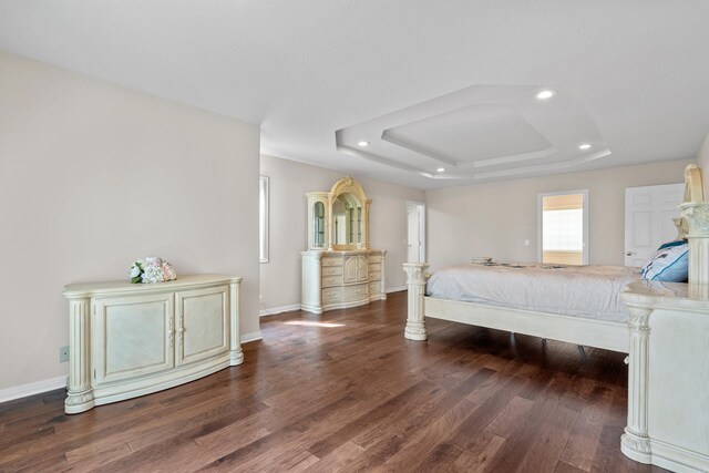 bedroom featuring a tray ceiling and hardwood / wood-style floors