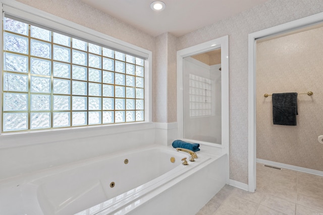 bathroom with a bath and tile patterned floors