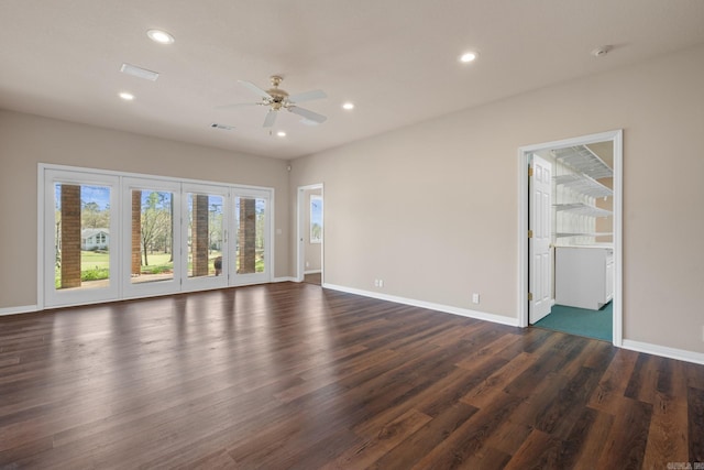 empty room featuring ceiling fan and dark hardwood / wood-style floors