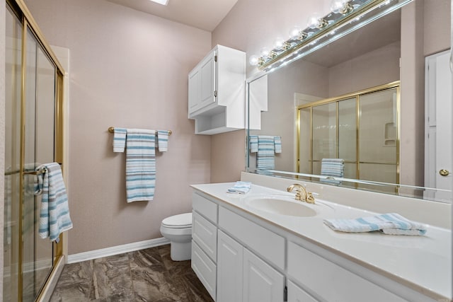 bathroom with vanity, a shower with shower door, and toilet