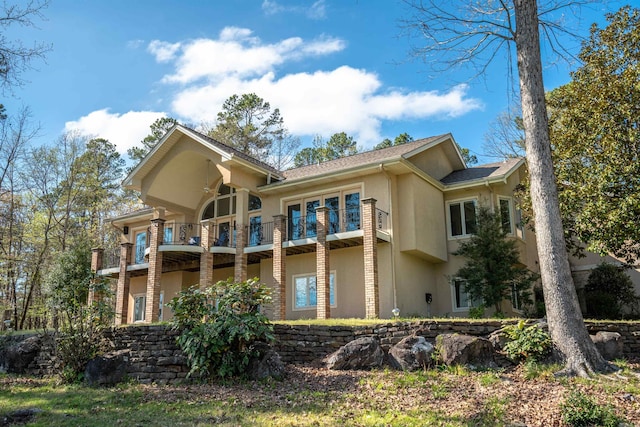 rear view of property featuring a balcony