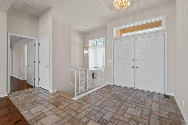 foyer featuring an inviting chandelier