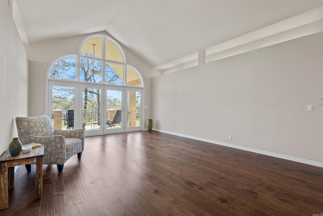 sitting room with dark hardwood / wood-style flooring, french doors, and high vaulted ceiling