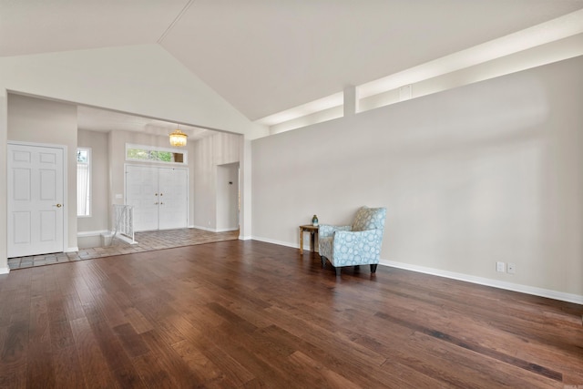 entrance foyer with dark hardwood / wood-style flooring and high vaulted ceiling