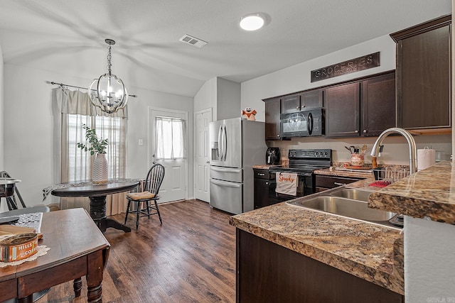 kitchen with dark brown cabinets, black appliances, a chandelier, and dark wood-type flooring