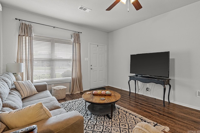 living room with ceiling fan and dark hardwood / wood-style flooring