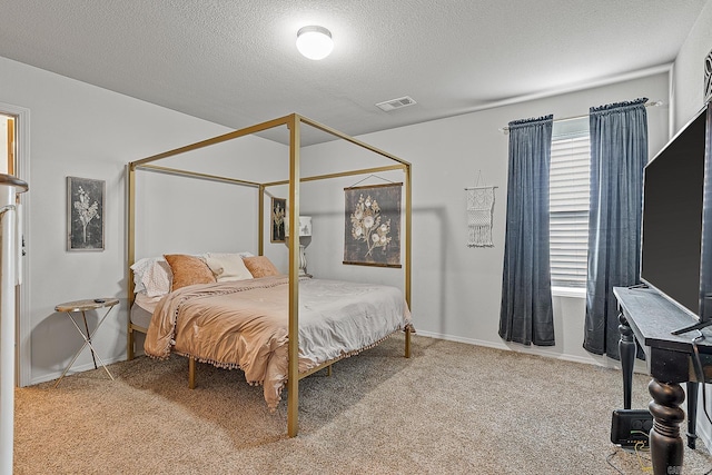 bedroom featuring a textured ceiling and carpet