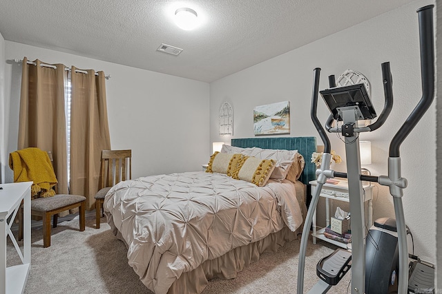 bedroom with a textured ceiling and carpet floors