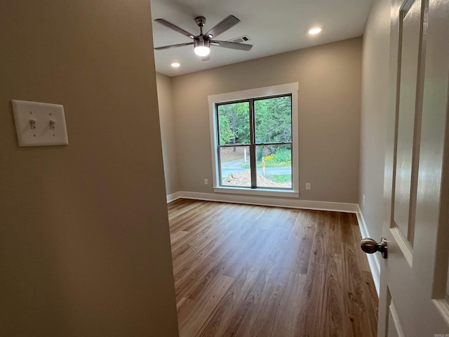 unfurnished room with wood-type flooring and ceiling fan