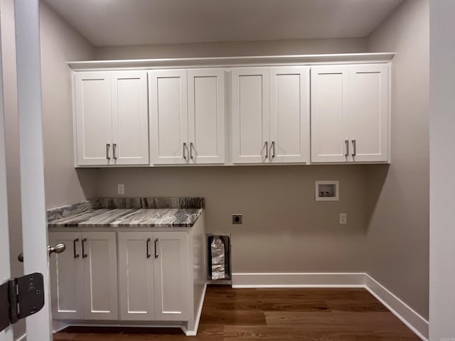 washroom with hookup for a washing machine, cabinets, dark hardwood / wood-style flooring, and electric dryer hookup