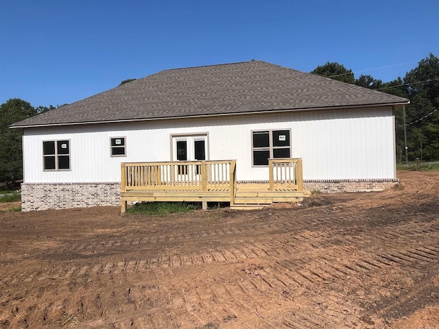 back of house featuring a wooden deck