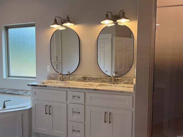 bathroom with a tub to relax in and vanity