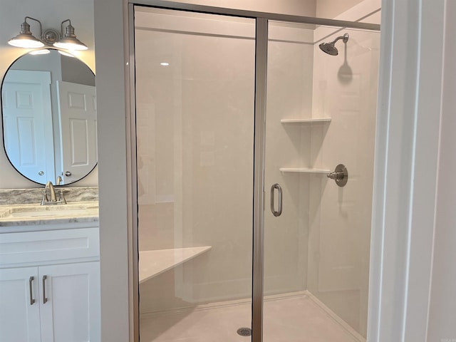 bathroom featuring vanity and an enclosed shower