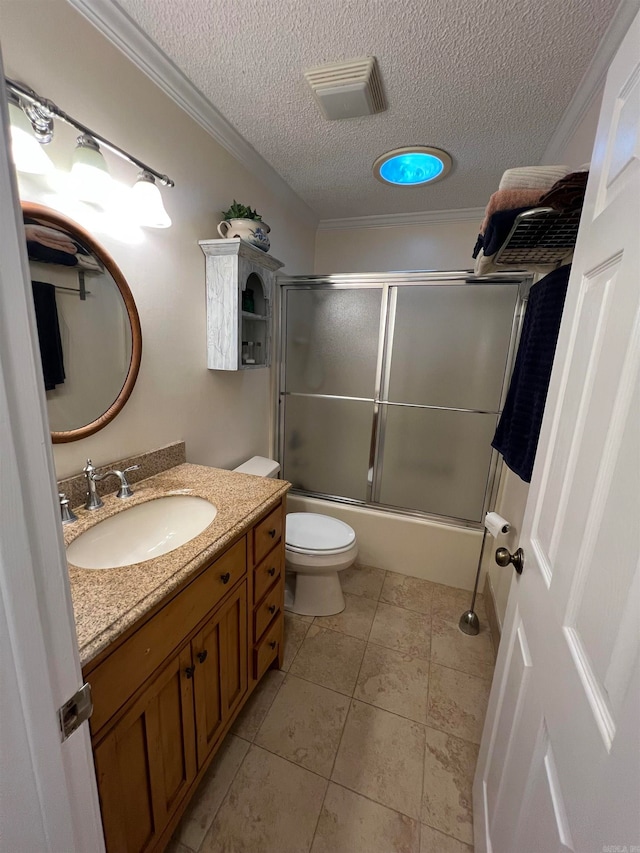 full bathroom with a textured ceiling, combined bath / shower with glass door, ornamental molding, vanity, and toilet