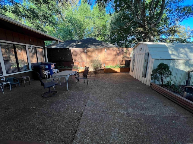 view of patio featuring a storage unit