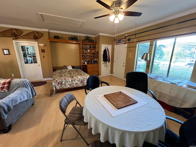 dining space featuring light hardwood / wood-style floors, ceiling fan, and crown molding