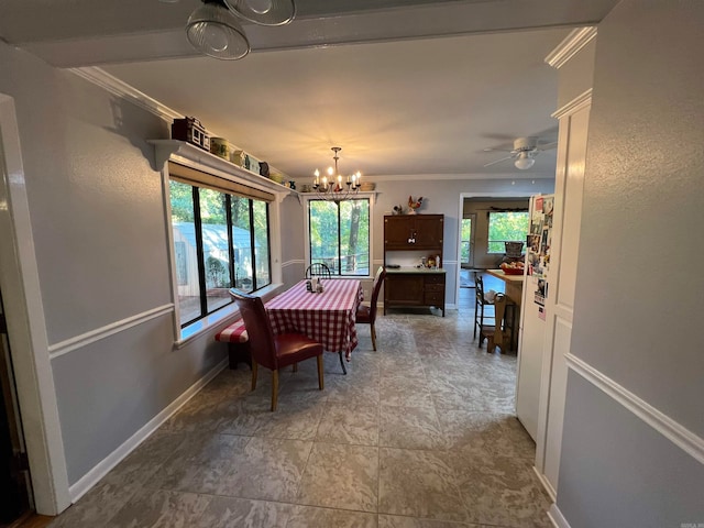 dining area with ceiling fan with notable chandelier, a healthy amount of sunlight, and crown molding