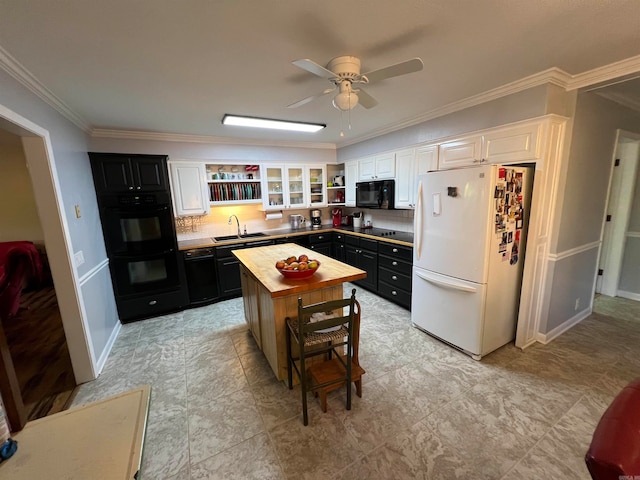 kitchen with ceiling fan, a kitchen island, white cabinetry, and black appliances