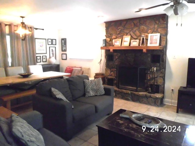 living room with ceiling fan, light tile patterned flooring, and a fireplace