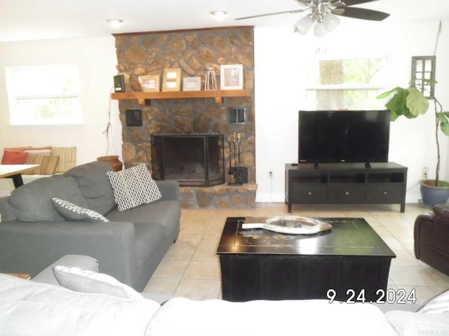 living room with ceiling fan, light tile patterned flooring, and a fireplace