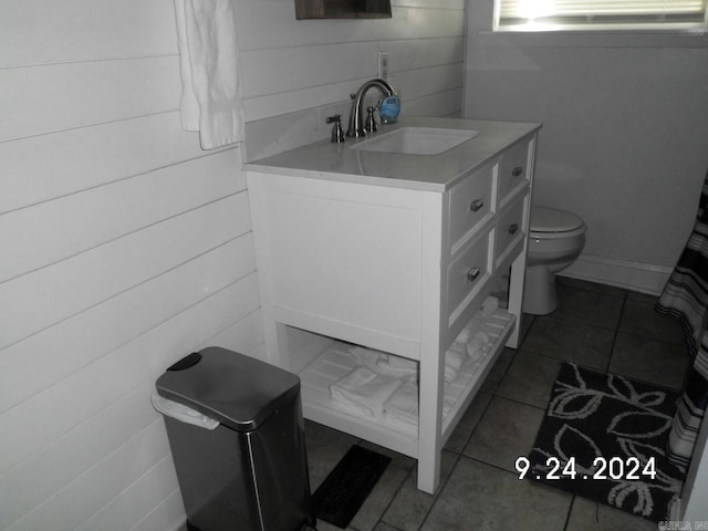 bathroom featuring vanity, tile patterned flooring, and toilet