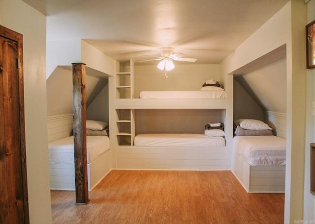 unfurnished bedroom with ceiling fan and hardwood / wood-style flooring