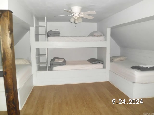 unfurnished bedroom with vaulted ceiling, ceiling fan, and hardwood / wood-style flooring