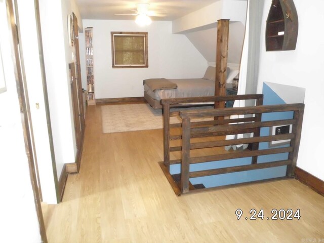 stairs featuring ceiling fan and wood-type flooring