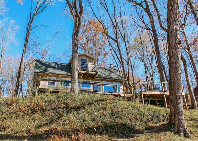 rear view of house featuring a deck