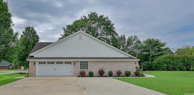 view of side of home featuring a garage and a yard