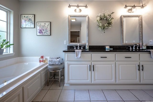 bathroom featuring vanity, tile patterned floors, and a tub