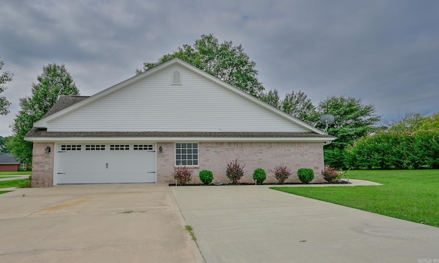 view of property exterior with a garage and a yard