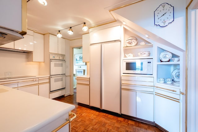 1 Treetops Unit & 1103, Little Rock, AR 72202 - kitchen featuring built in appliances, light countertops, white cabinetry, crown molding, and open shelves