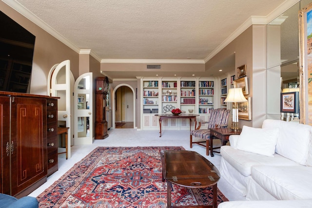 1 Treetops Unit & 1103, Little Rock, AR 72202 - living area featuring arched walkways, a textured ceiling, light colored carpet, and ornamental molding