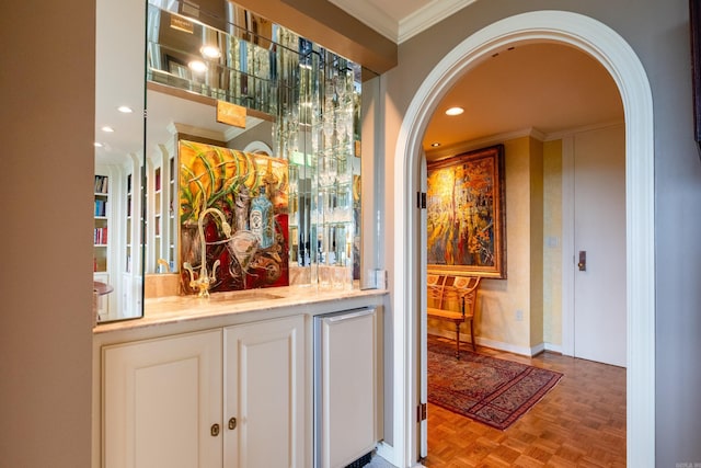 1 Treetops Unit & 1103, Little Rock, AR 72202 - indoor bar featuring arched walkways, crown molding, recessed lighting, and fridge