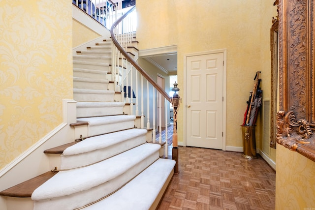 1 Treetops Unit & 1103, Little Rock, AR 72202 - foyer featuring a high ceiling, stairway, wallpapered walls, and baseboards