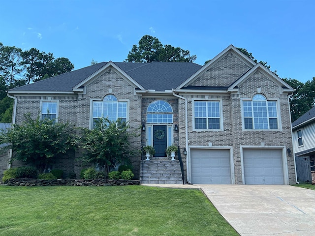 view of front of house with a front yard and a garage