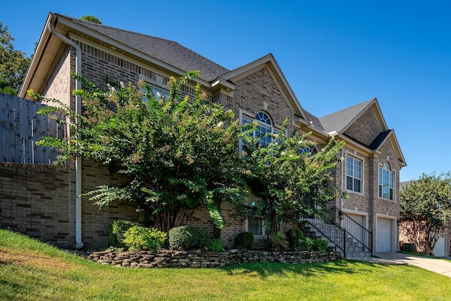 view of front of property with a front yard and a garage