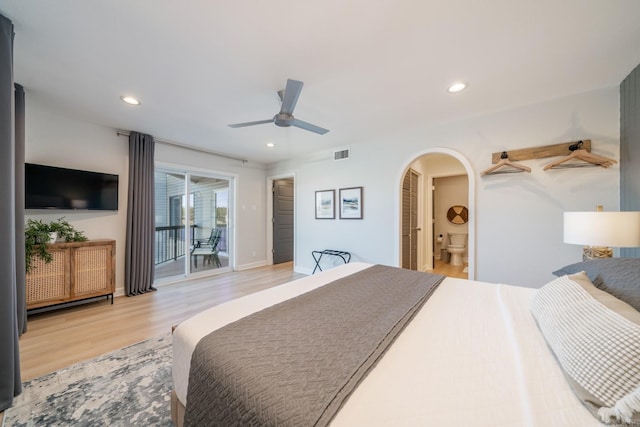 bedroom featuring ceiling fan, access to exterior, ensuite bathroom, and light hardwood / wood-style floors