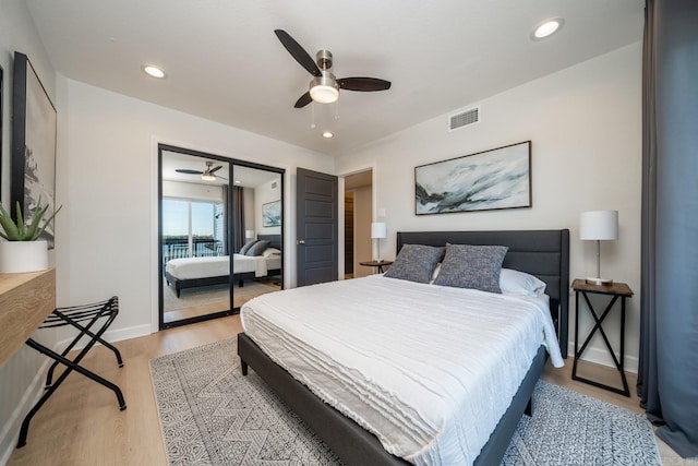 bedroom with ceiling fan, a closet, and light hardwood / wood-style floors