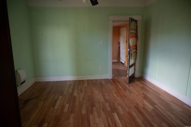 unfurnished room featuring ceiling fan and hardwood / wood-style floors