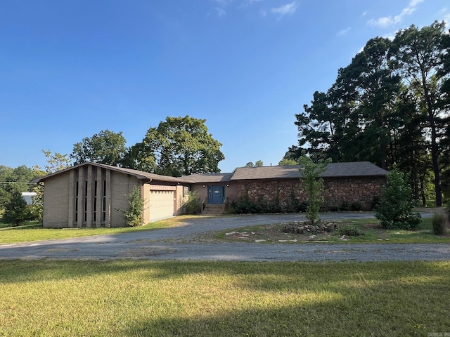 ranch-style home with a garage and a front lawn