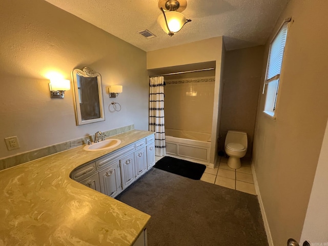 full bathroom with shower / bath combination with curtain, vanity, a textured ceiling, tile patterned floors, and toilet