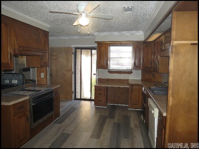 kitchen with crown molding, ceiling fan, electric range, and dark hardwood / wood-style flooring