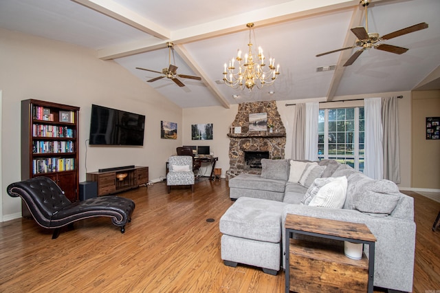 living room featuring ceiling fan with notable chandelier, light hardwood / wood-style flooring, lofted ceiling with beams, and a fireplace