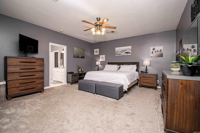 carpeted bedroom with connected bathroom and ceiling fan