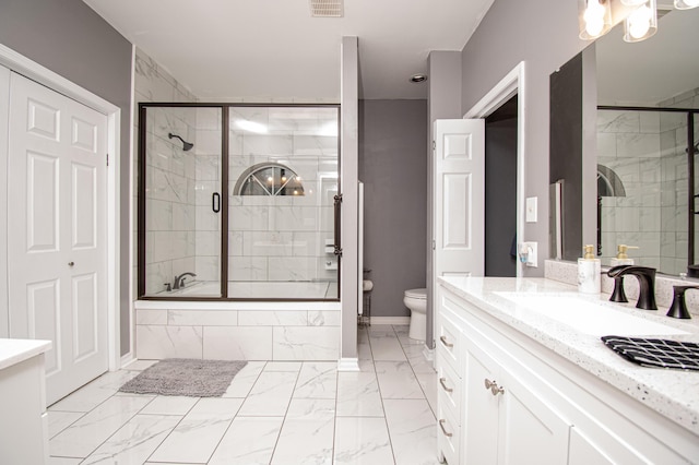 full bathroom featuring shower / bath combination with glass door, vanity, and toilet